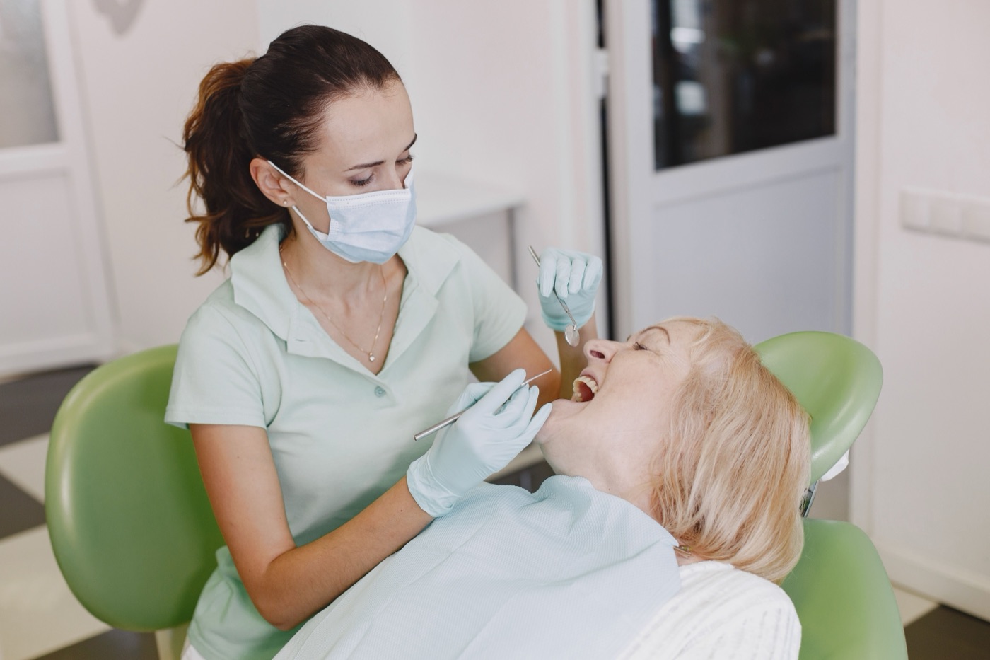 Dentist examining a patient at the clinic